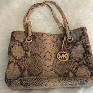Michael Kors snakeskin purse with gold accents.